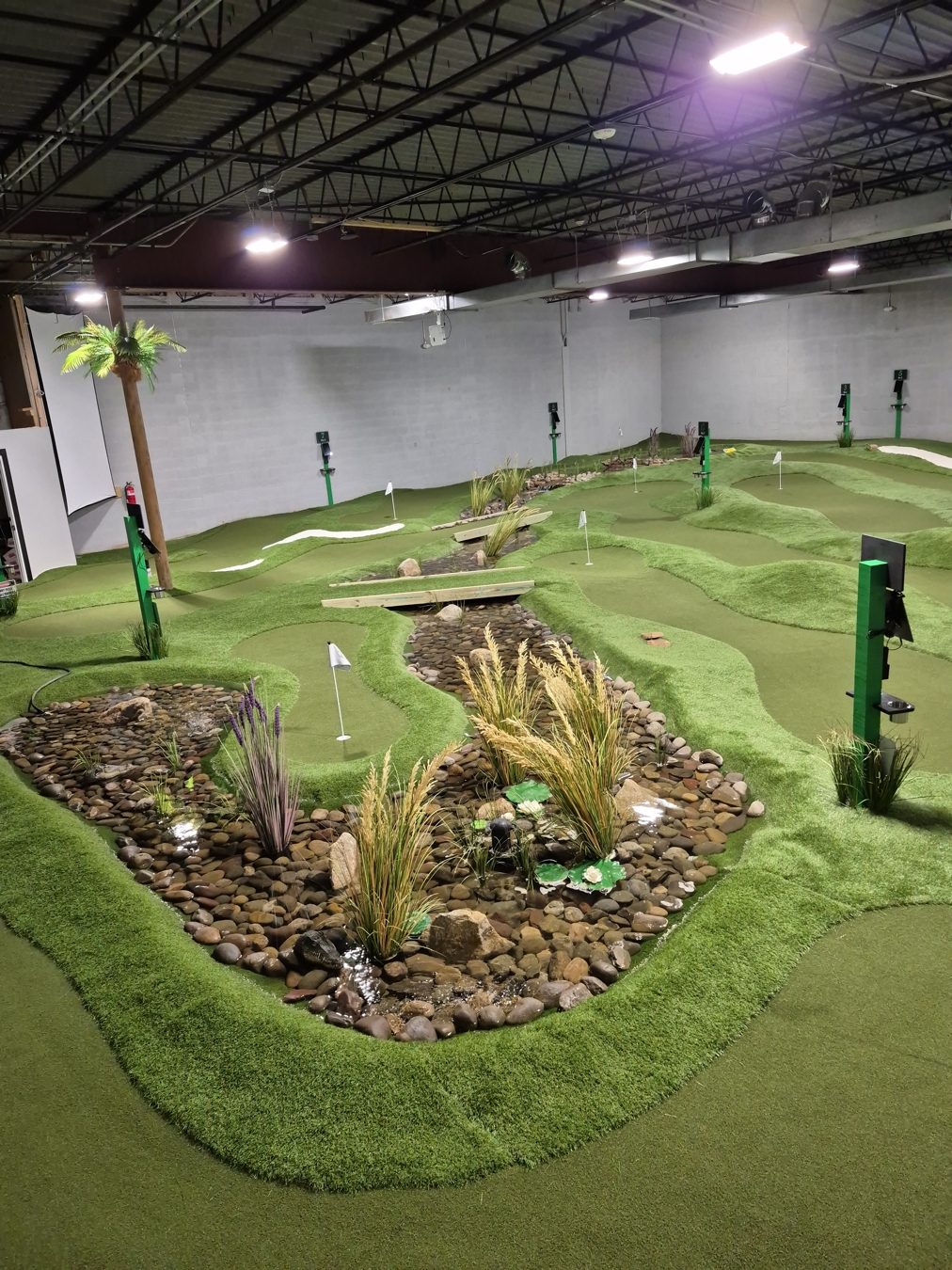 Indoor mini golf course and landscaped putting greens at Swing Evolutions